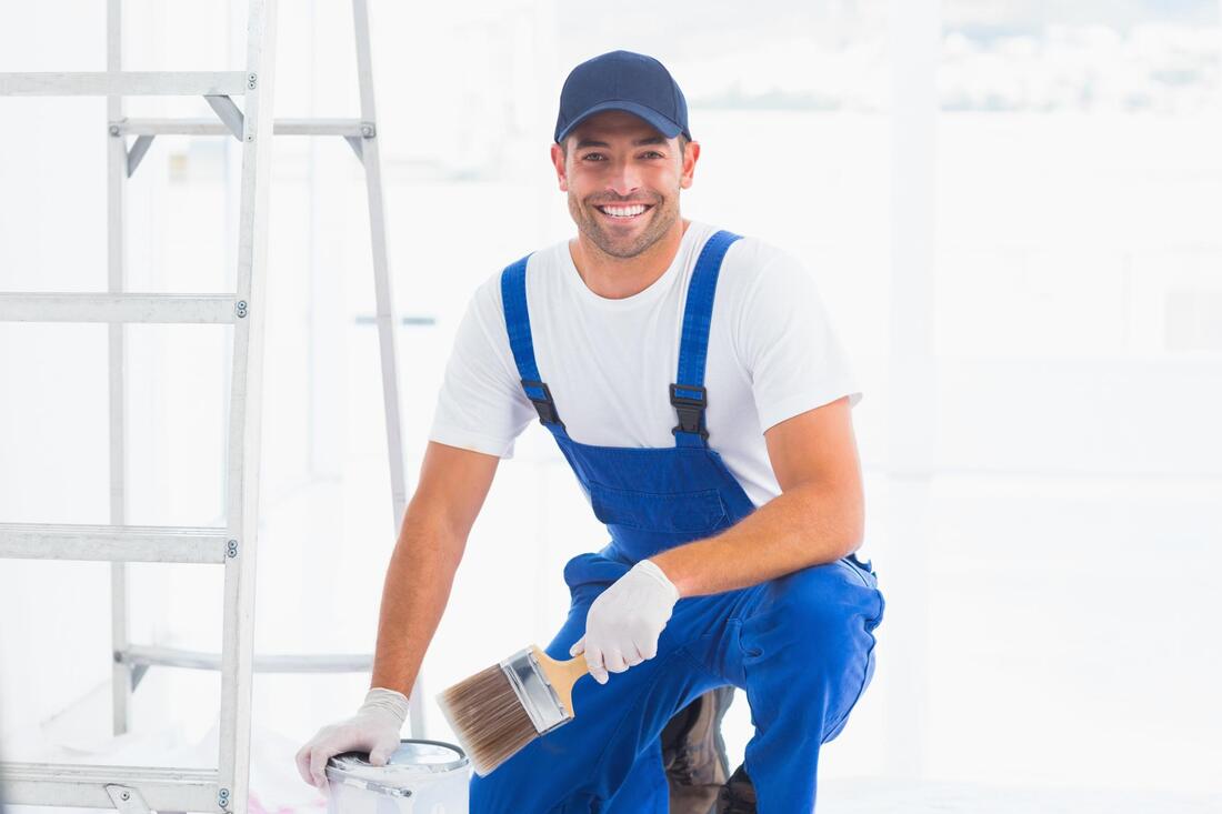 smiling painter working ladder
