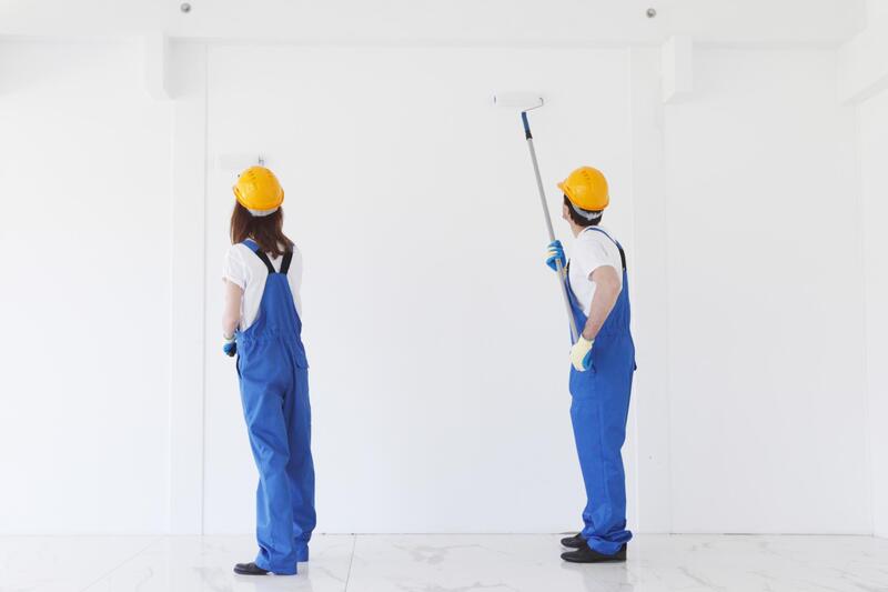 two workers uniforms painting on wall